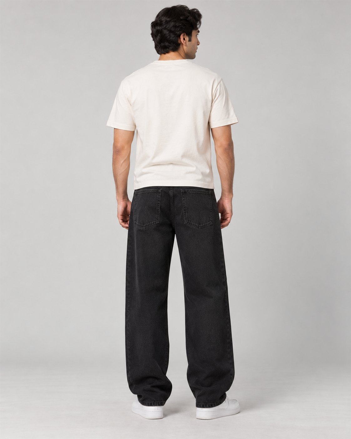 Men wearing black relaxed wide-leg jeans, back view
