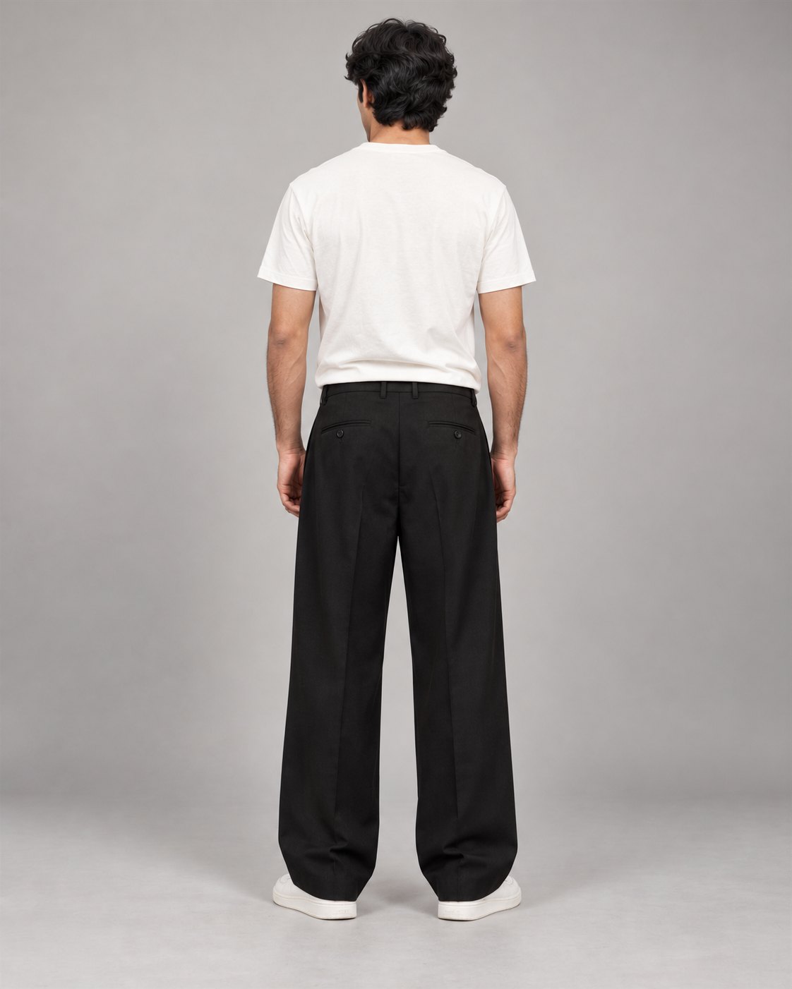 Men wearing black relaxed wide-leg trousers, back view